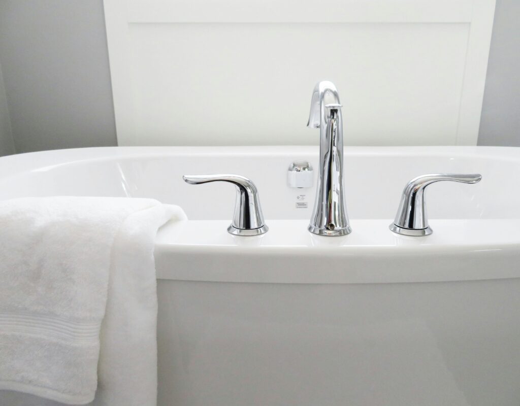 white bathtub with towel