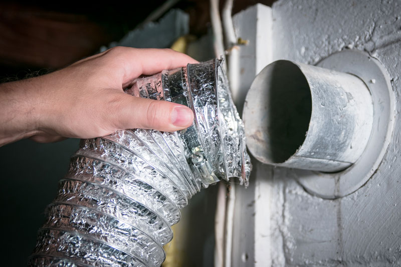 person replacing dryer vent