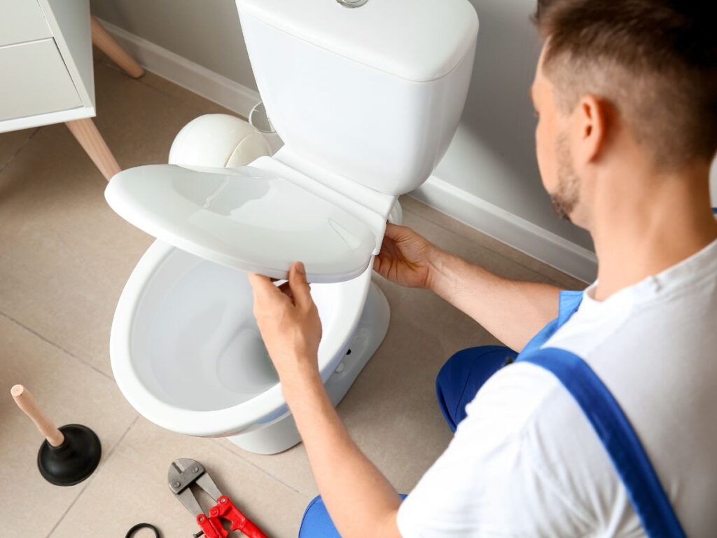 plumber installing a new toilet