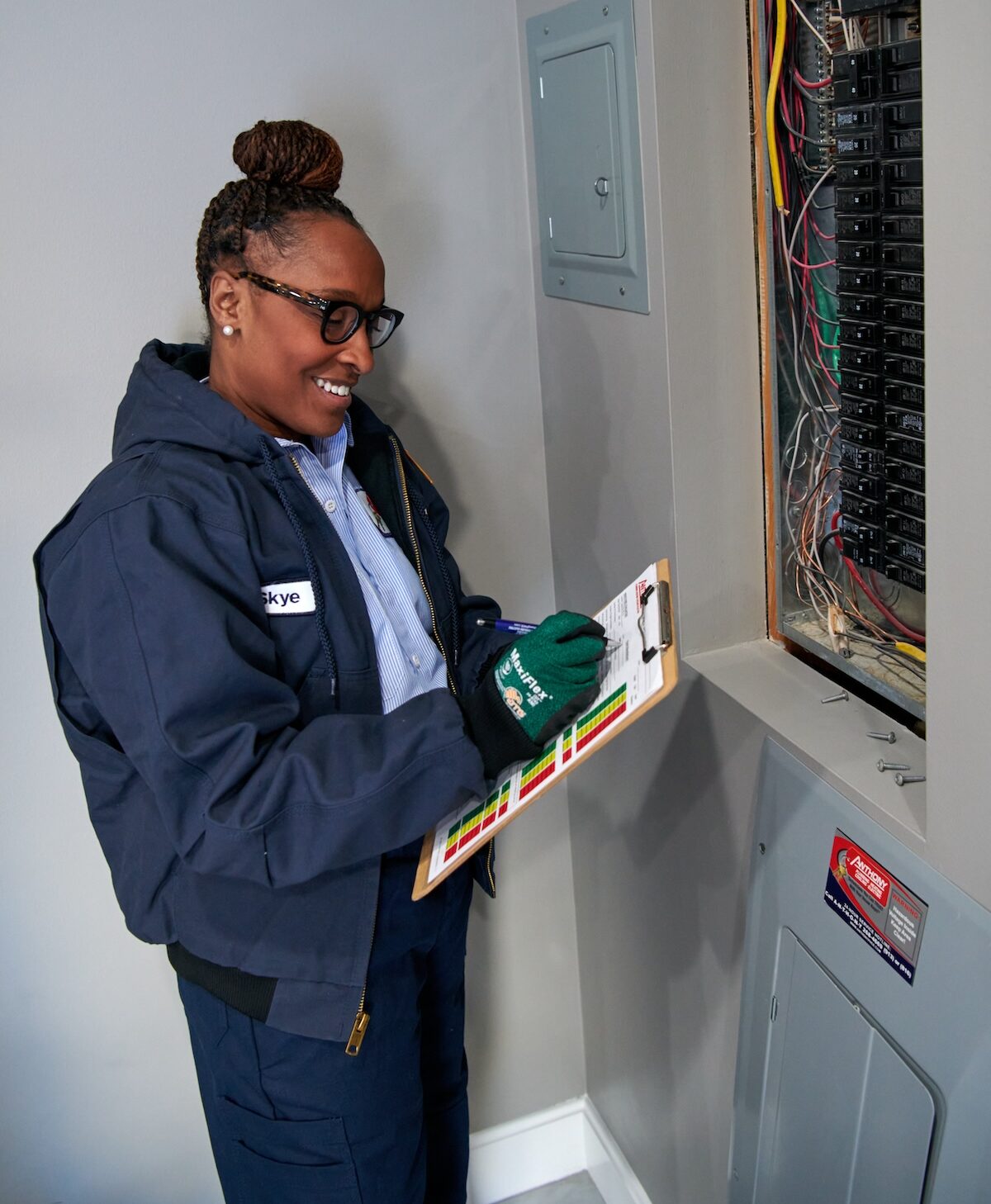 Technician working on electrical panel