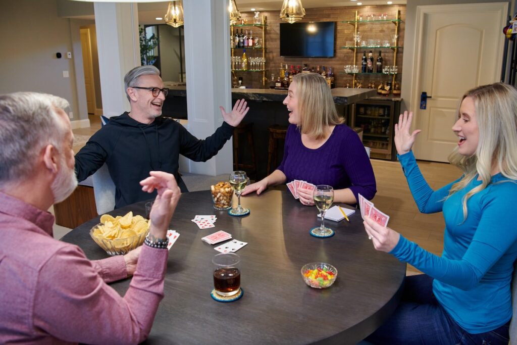 Group of people drinking wine and playing cards