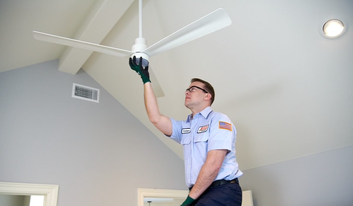 technician working on ceiling fan