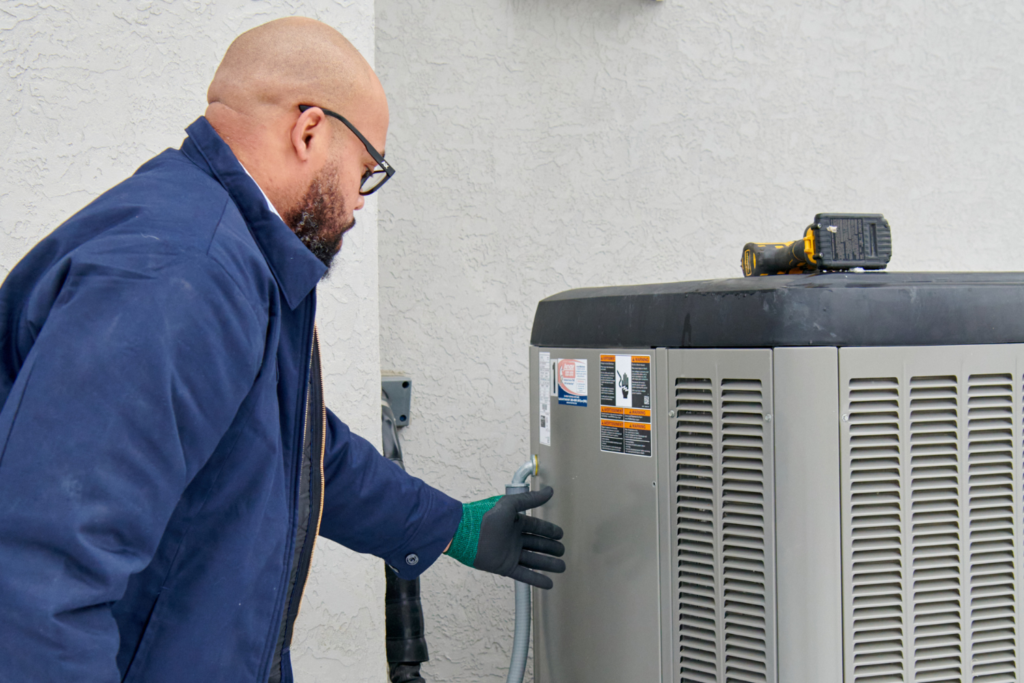 HVAC technician inspecting air conditioner