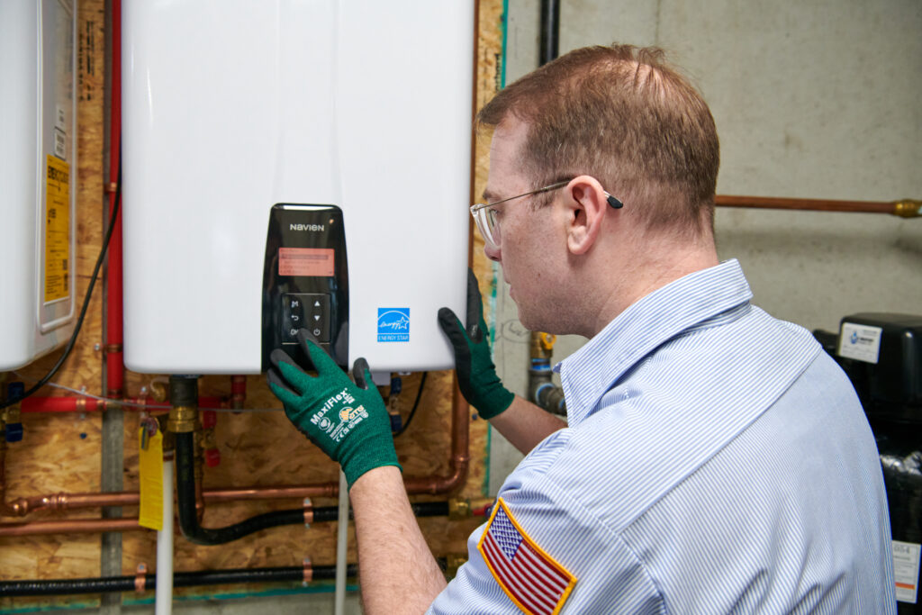 plumber installing a tankless water heater