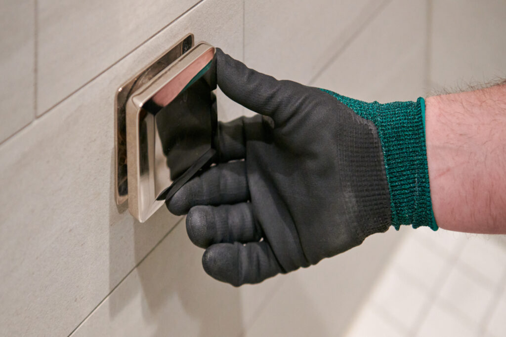 local plumber working on shower setup