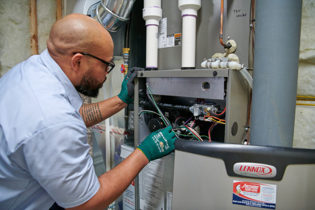 HVAC tech working on a heating system