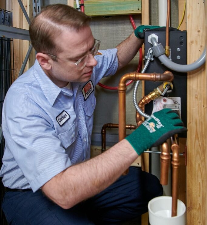 plumber working on pipes